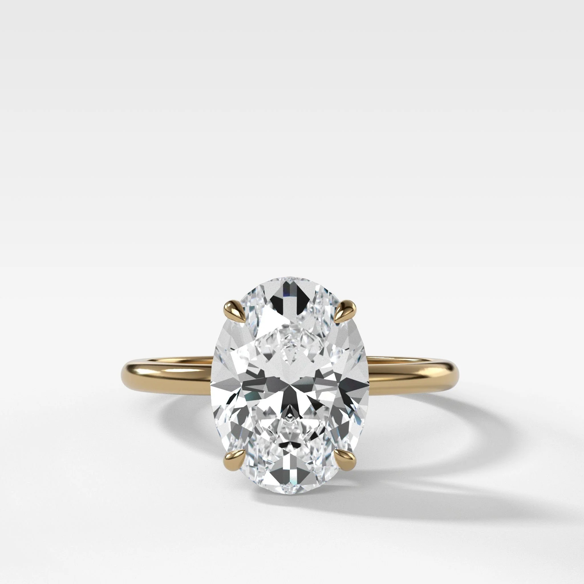 GOODSTONE Thin and Simple Solitaire engagement ring with oval cut diamond in 14K yellow gold