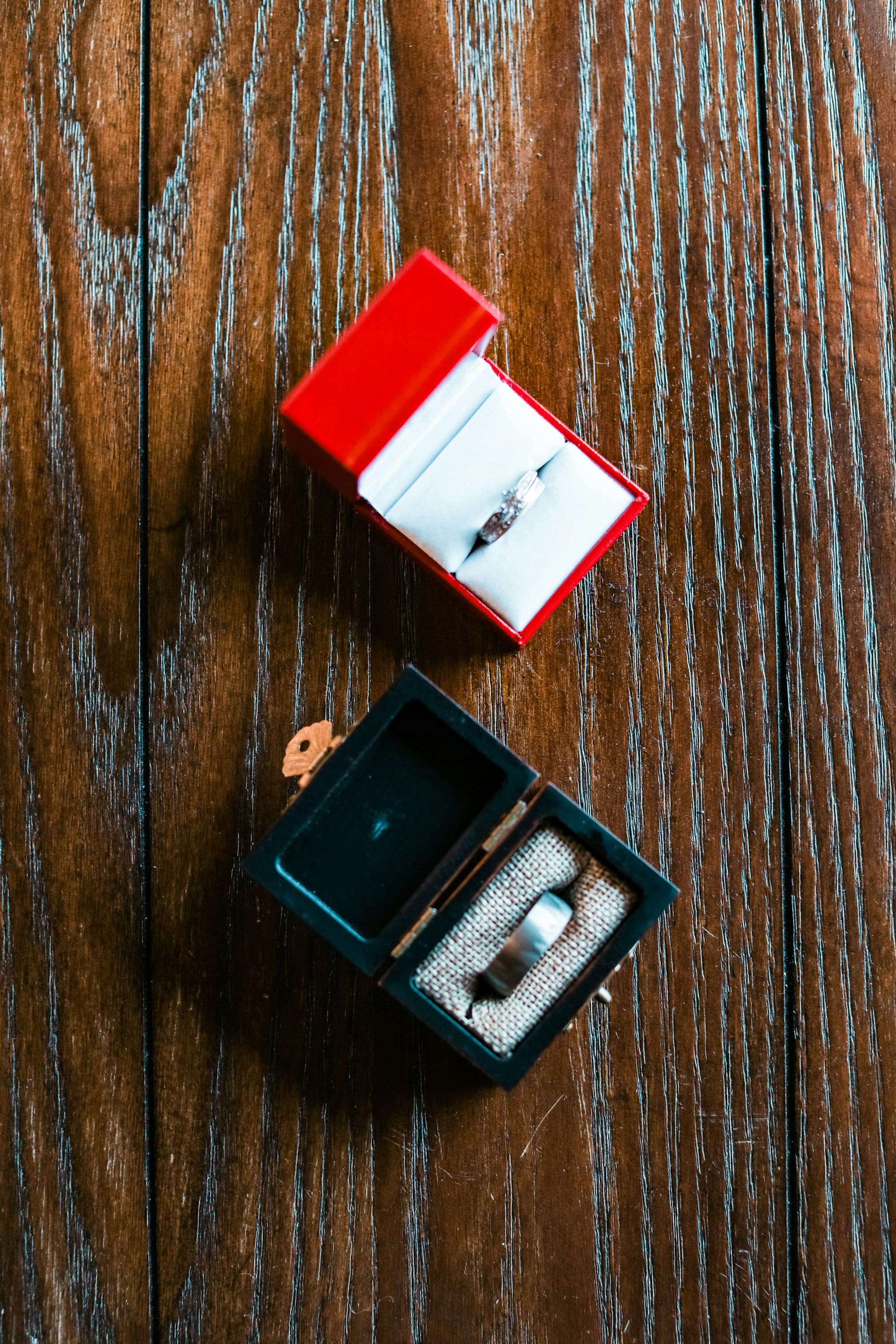 An open ring box on a wooden table